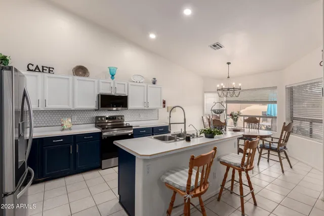a kitchen with stainless steel appliances kitchen island granite countertop a sink and cabinets