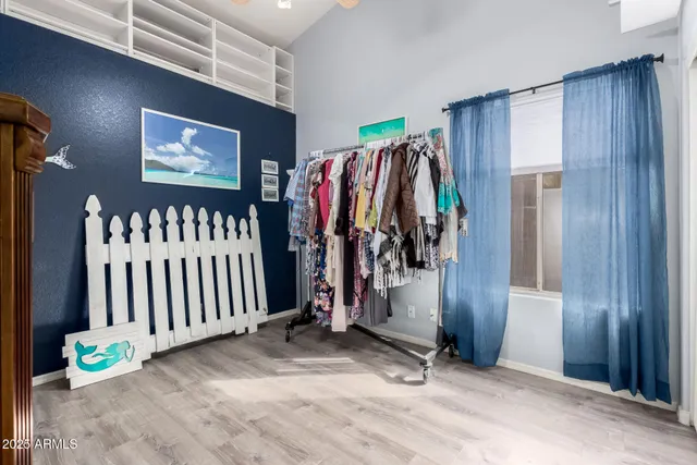 a view of walk in closet with clothes