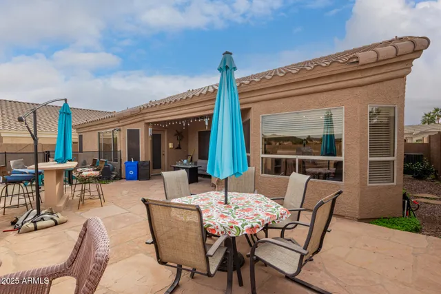 a view of a patio with couches table and chairs and potted plants