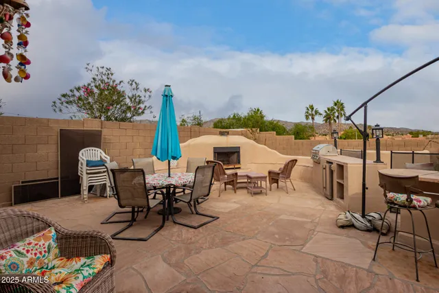 a view of a patio with table and chairs potted plants with wooden floor