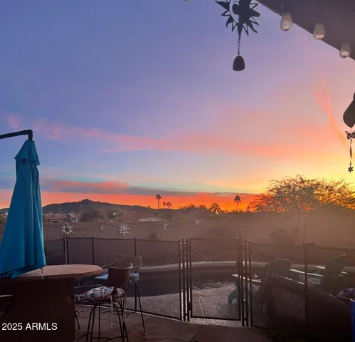 a view of a terrace with a table and chairs