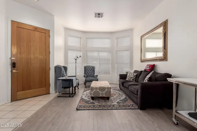a living room with furniture windows and a wooden floor