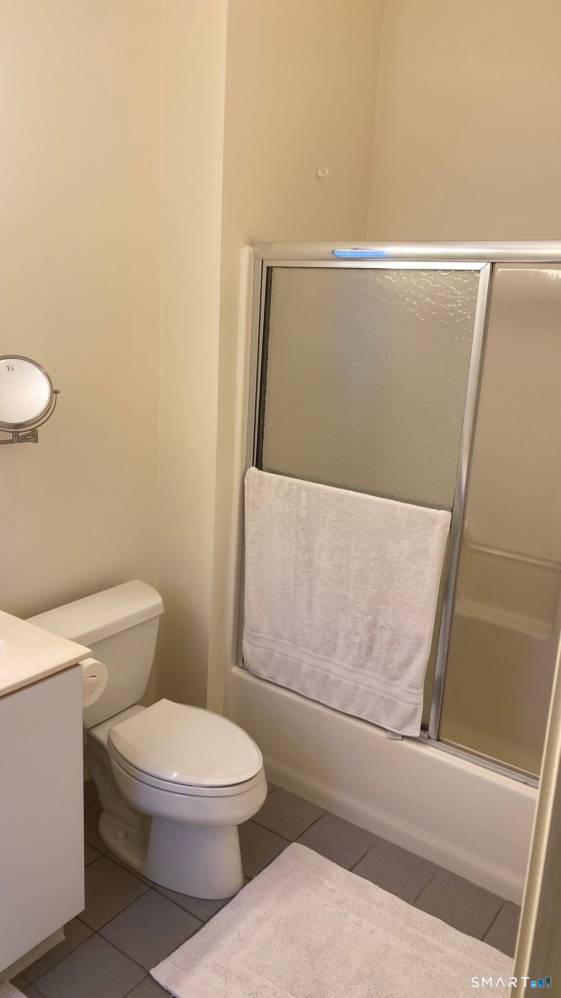 403 Larson Drive, Unit 403 Danbury, CT 06810 - Photo 16 of 34 a white toilet sitting next to a bathroom sink