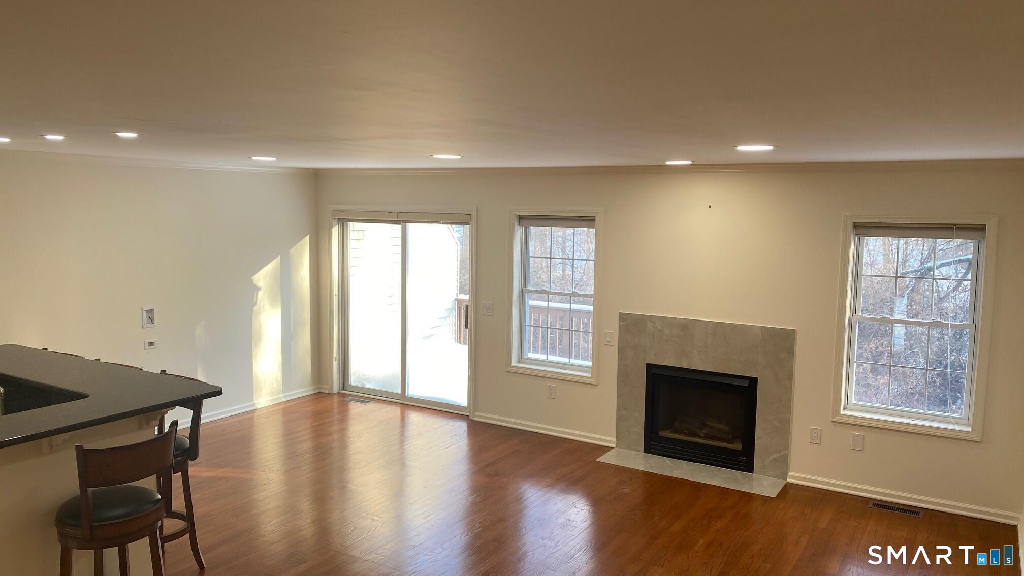 403 Larson Drive, Unit 403 Danbury, CT 06810 - Photo 2 of 34 a view of an empty room with wooden floor and a window