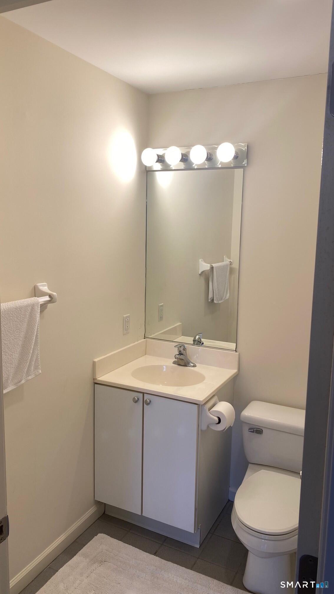 403 Larson Drive, Unit 403 Danbury, CT 06810 - Photo 21 of 34 a bathroom with a toilet a sink and mirror