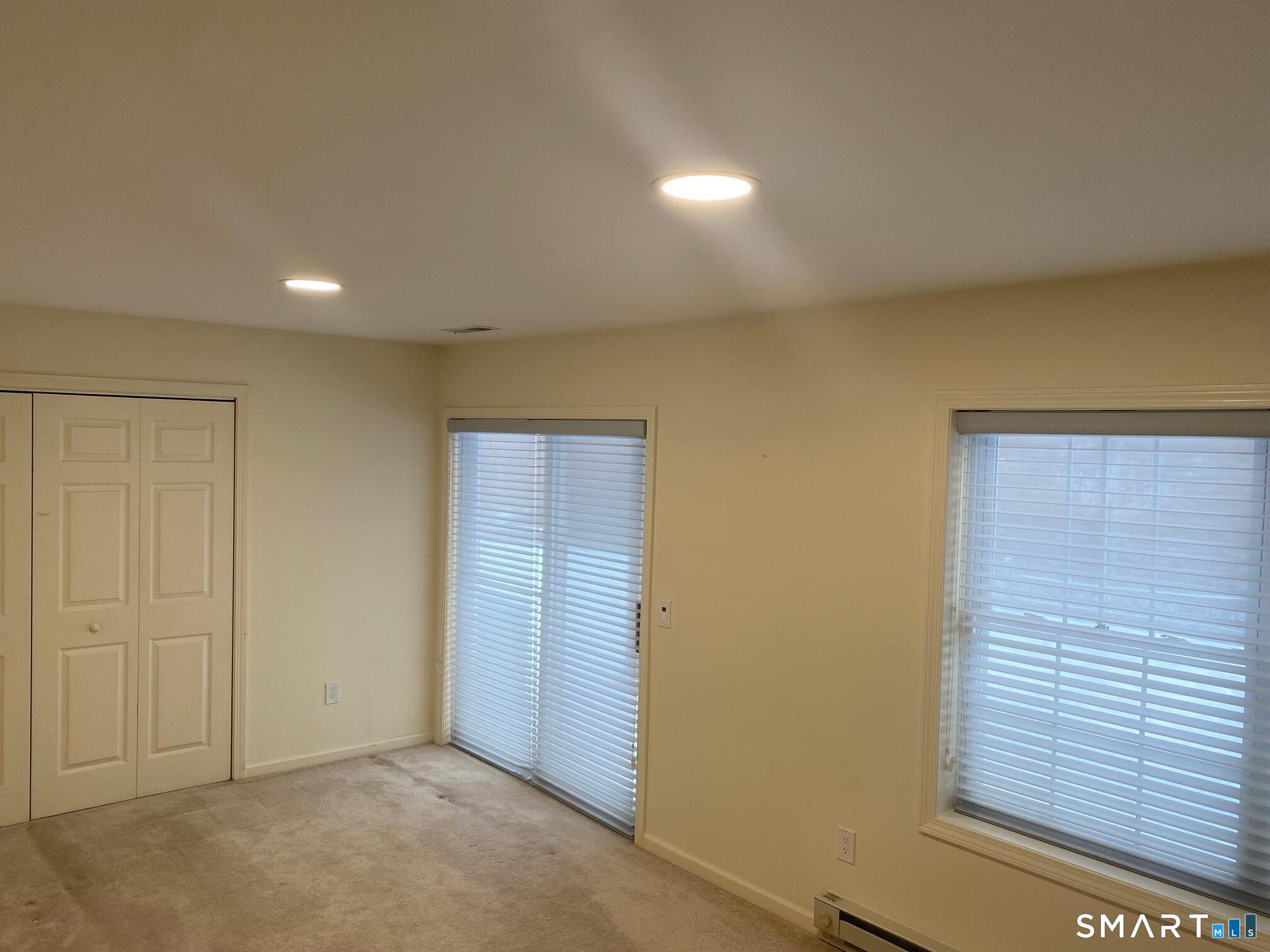403 Larson Drive, Unit 403 Danbury, CT 06810 - Photo 27 of 34 an empty room with windows