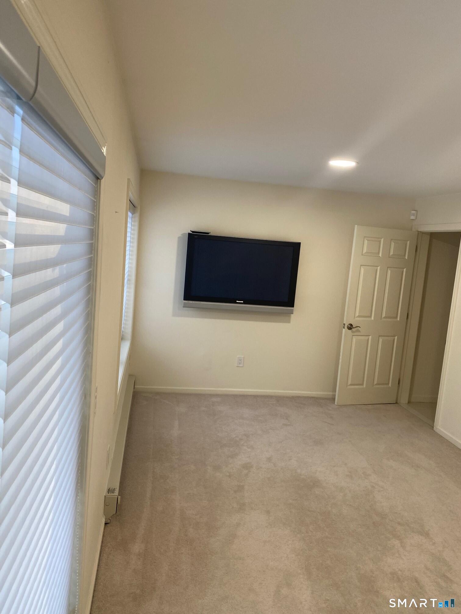 403 Larson Drive, Unit 403 Danbury, CT 06810 - Photo 28 of 34 a view of an empty room with windows