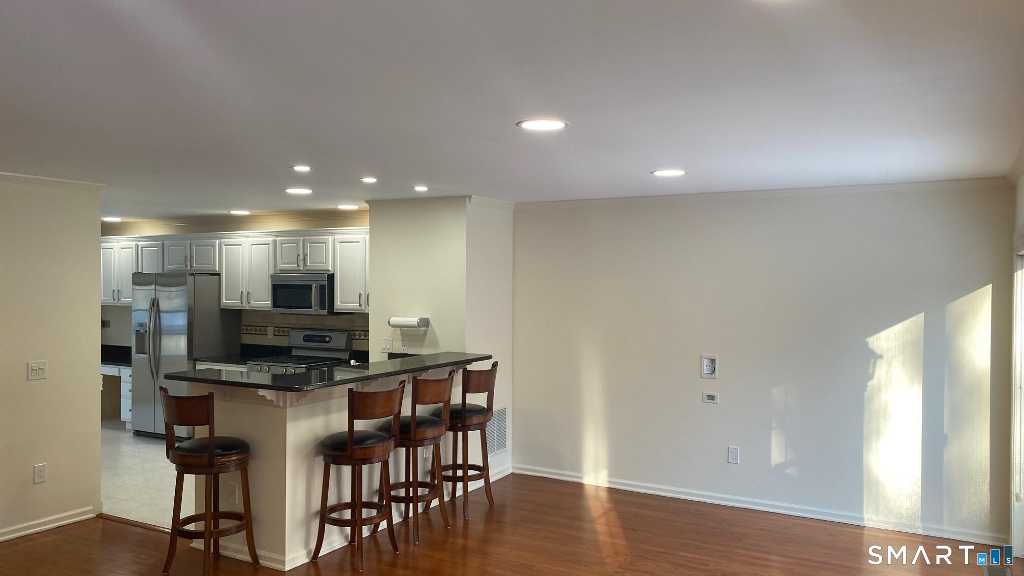 403 Larson Drive, Unit 403 Danbury, CT 06810 - Photo 4 of 34 a kitchen with stainless steel appliances a refrigerator and a stove top oven