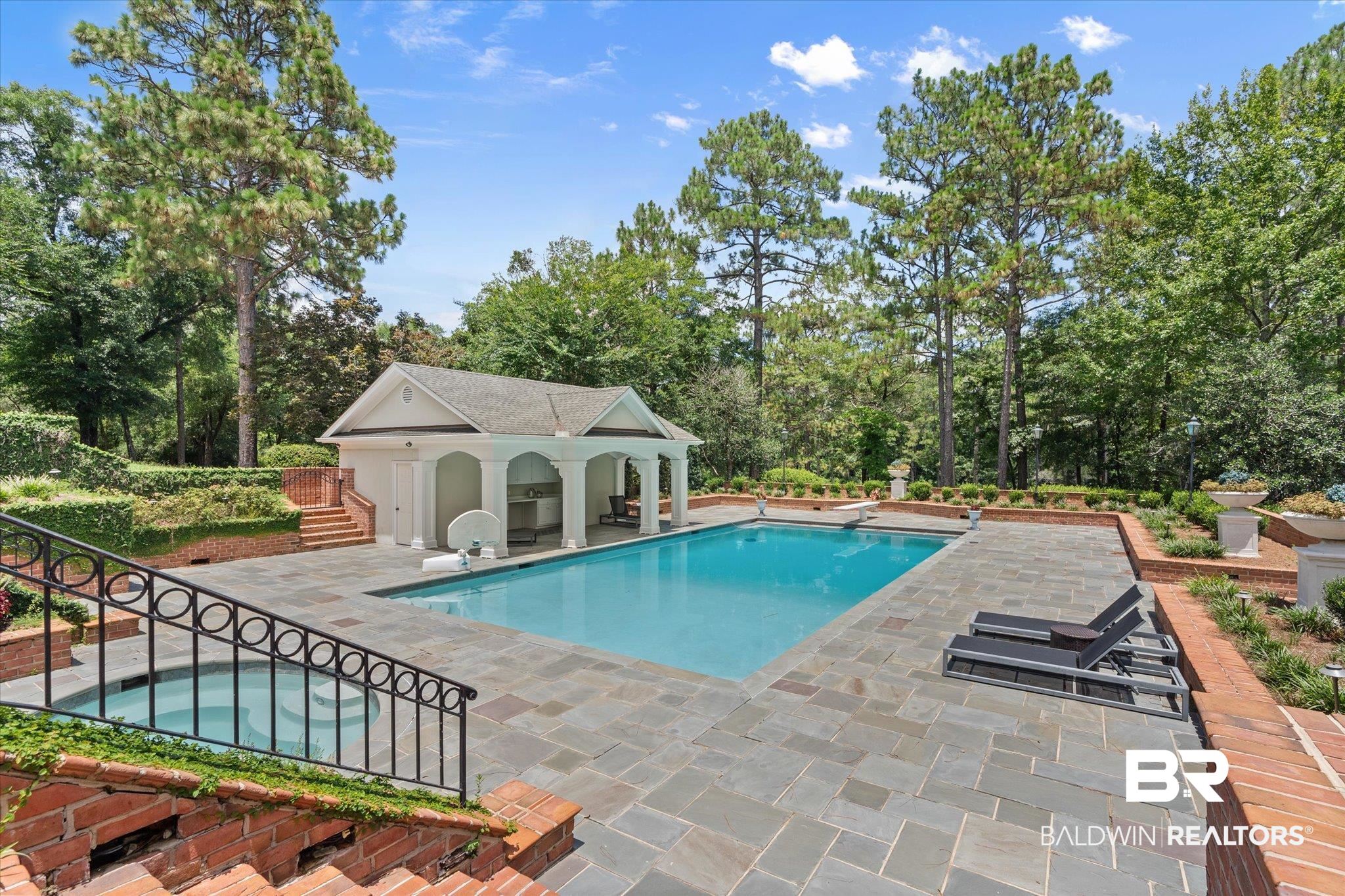 8561 Dawes Lake Road Mobile, AL 36619 - Photo 42 of 63 Swimming pool with an in-ground hot tub, a patio, an outdoor structure, a storage structure, and view of wooded area