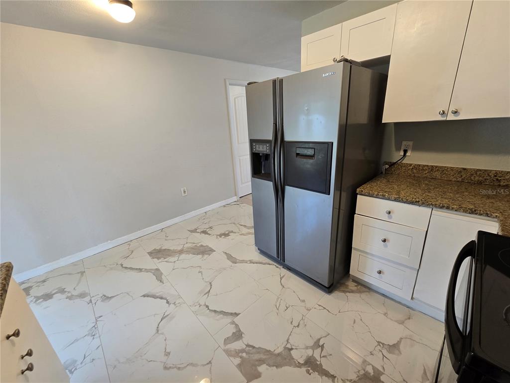 3406 Murrow Street New Port Richey, FL 34655 - Photo 12 of 21 a kitchen with stainless steel appliances granite countertop a refrigerator and a stove top oven