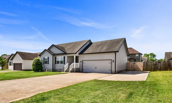 a front view of a house with a yard and garage
