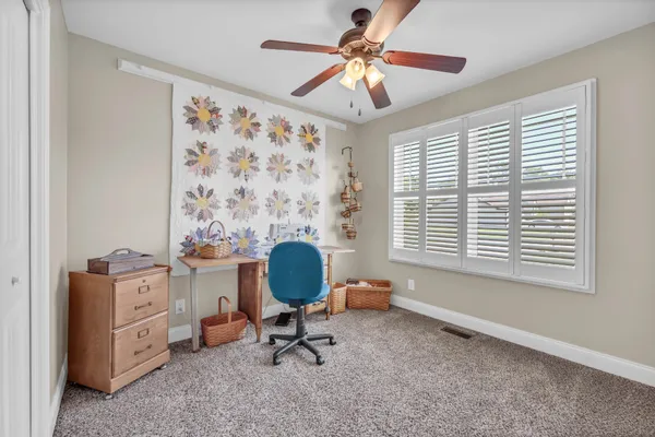a view of a workspace with a window and a chair