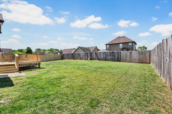 a backyard of a house with lots of green space