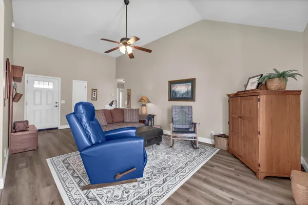 a living room with furniture a couch and wooden floor