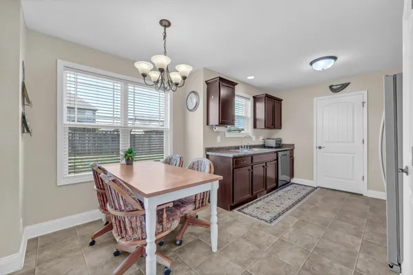 a open kitchen with stainless steel appliances granite countertop a stove a sink a oven a dining table and chairs