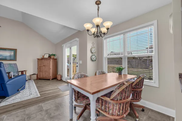 a view of a dining room with furniture wooden floor and chandelier