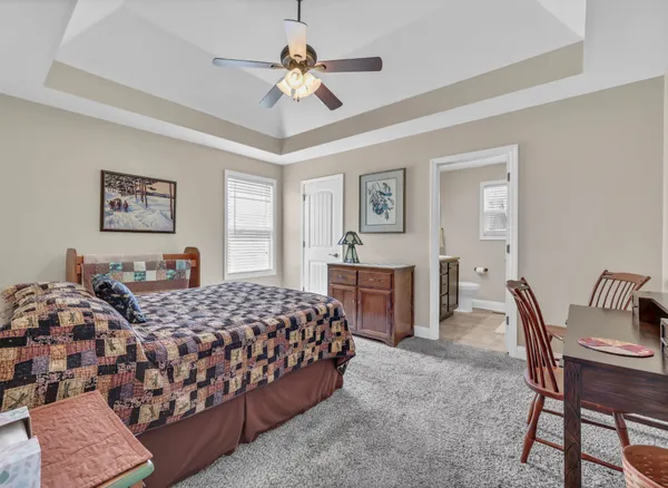 a bedroom with bed and a chandelier