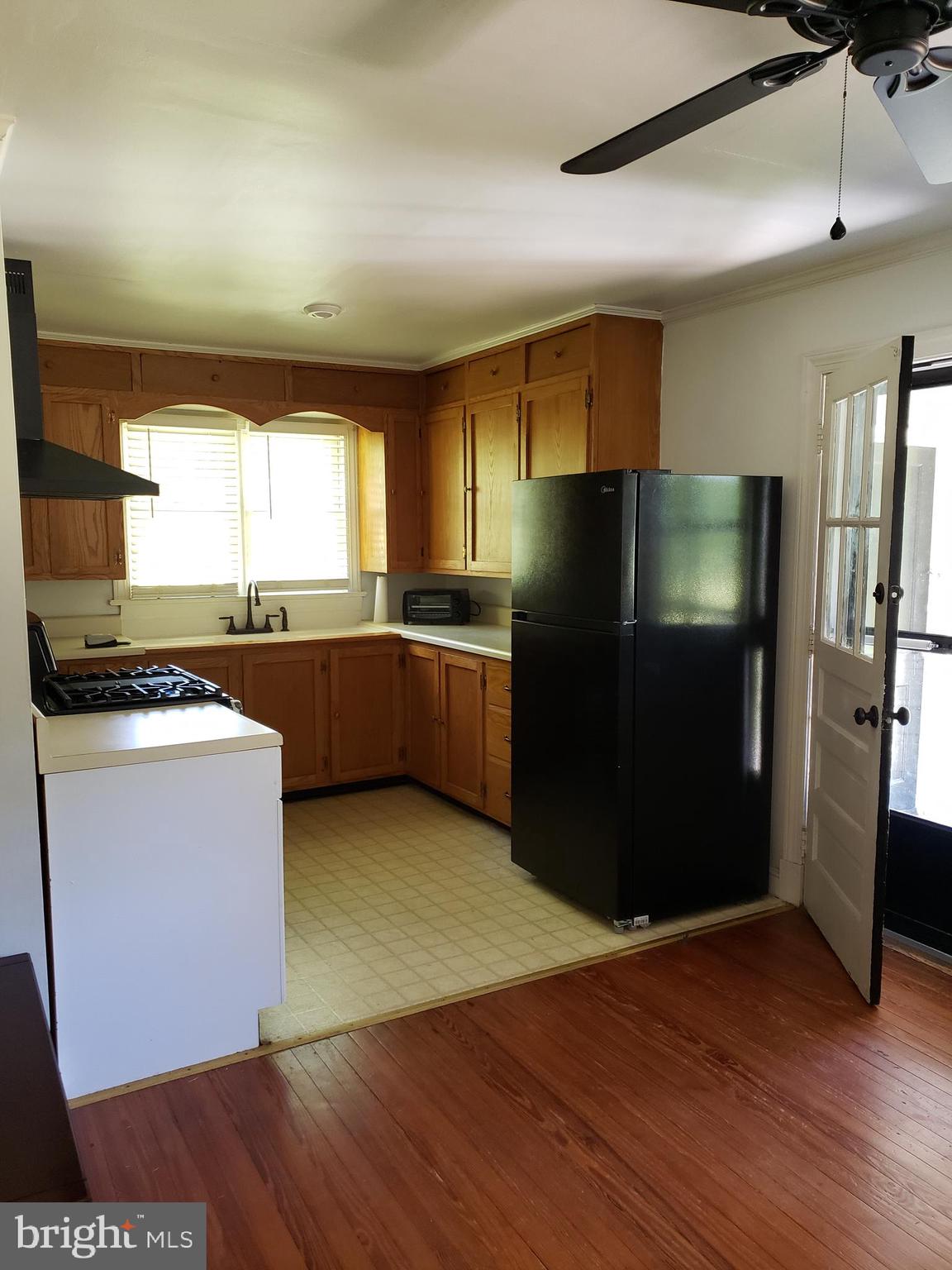 38799-38795 Hughesville Road Leesburg, VA 20175 - Photo 3 of 9 a kitchen with stainless steel appliances granite countertop a refrigerator and a sink