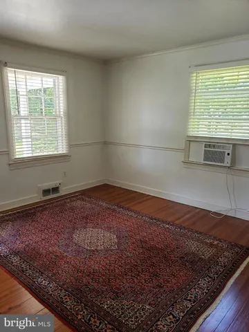 a view of a room with a wooden floor and a window