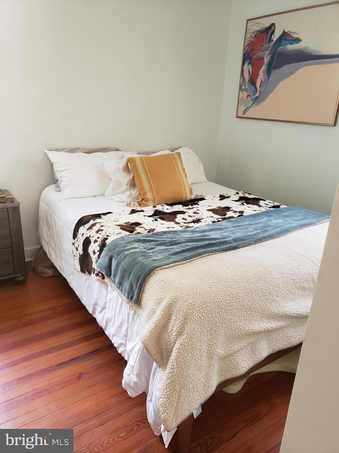 38799-38795 Hughesville Road Leesburg, VA 20175 - Photo 7 of 9 a bedroom with a bed and wooden floor