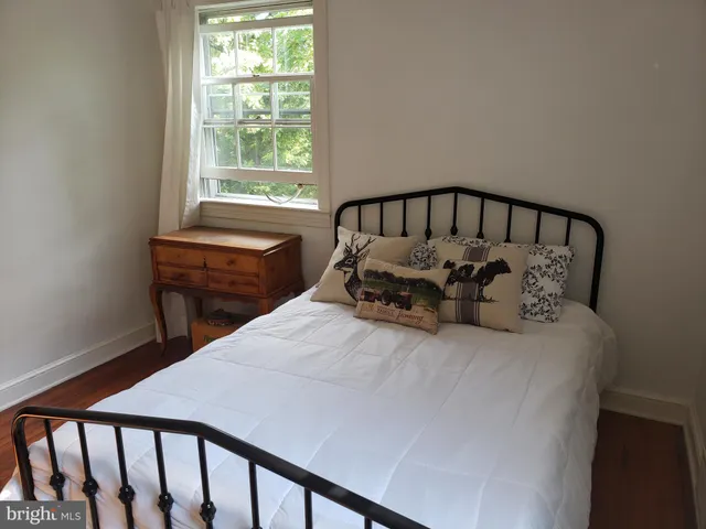 a bed sitting in a bedroom next to a window