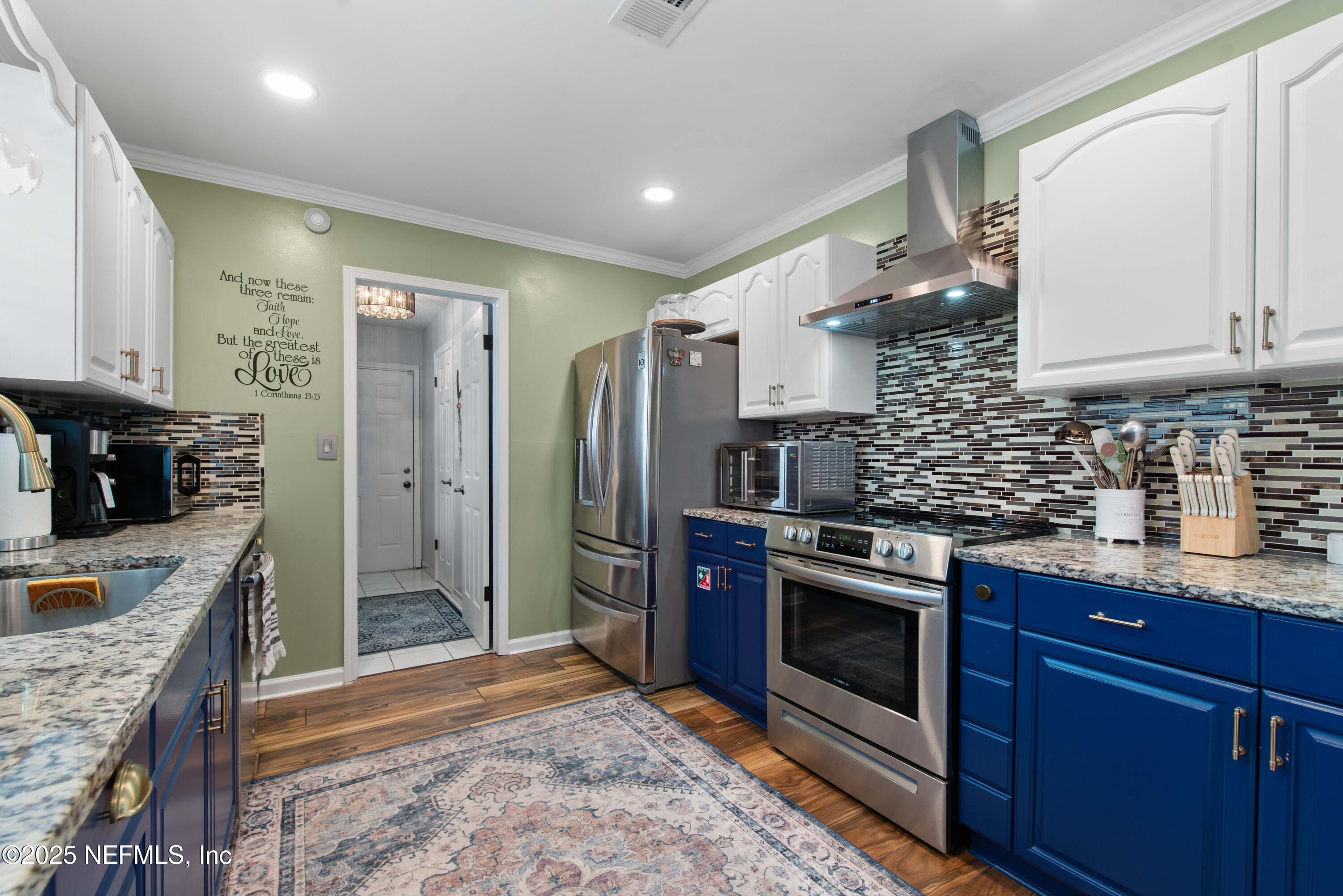 2894 Circle Ridge Drive Orange Park, FL 32065 - Photo 12 of 30 a kitchen with stainless steel appliances granite countertop a stove a sink and a refrigerator
