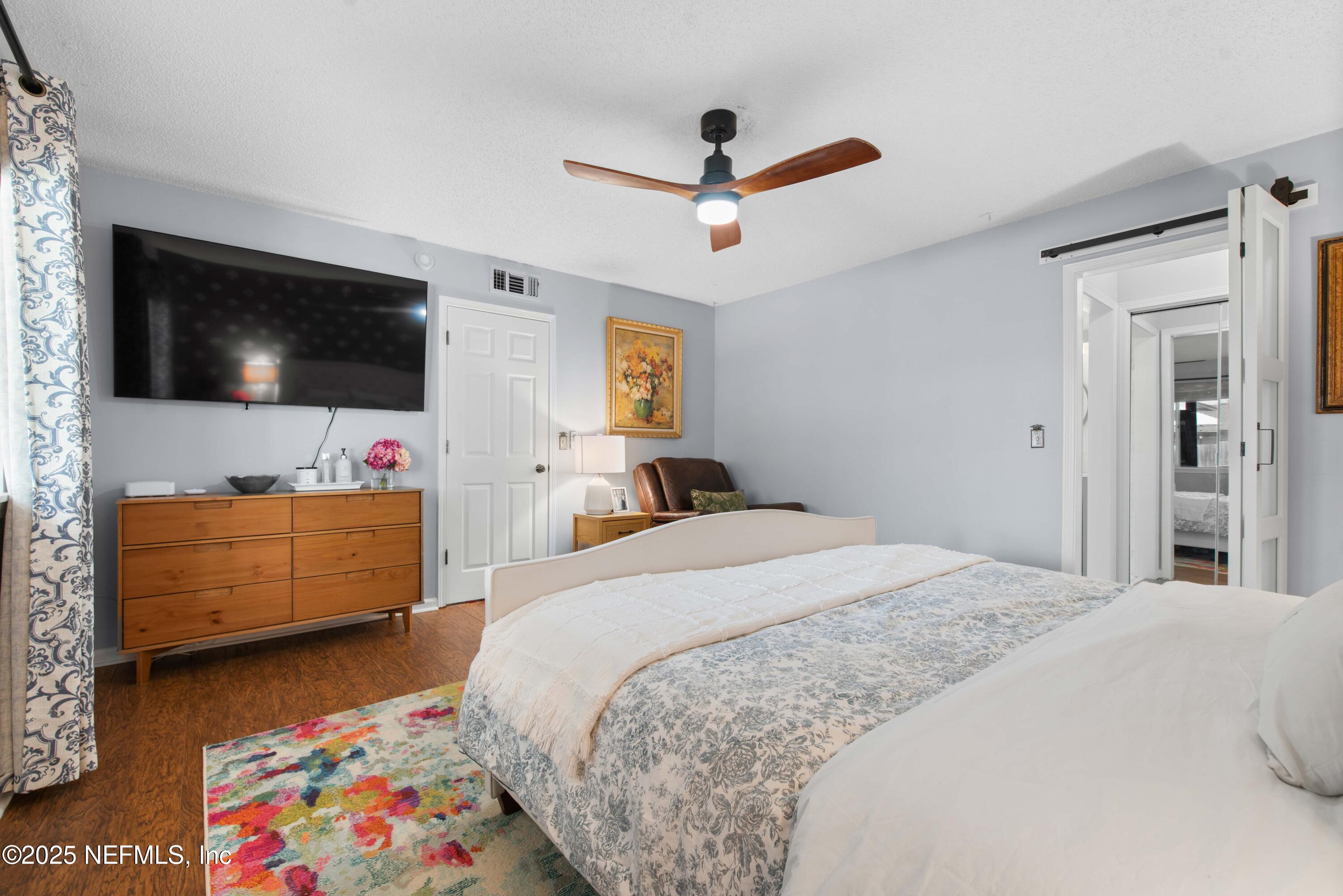 2894 Circle Ridge Drive Orange Park, FL 32065 - Photo 16 of 30 a bedroom with a bed and a flat screen tv