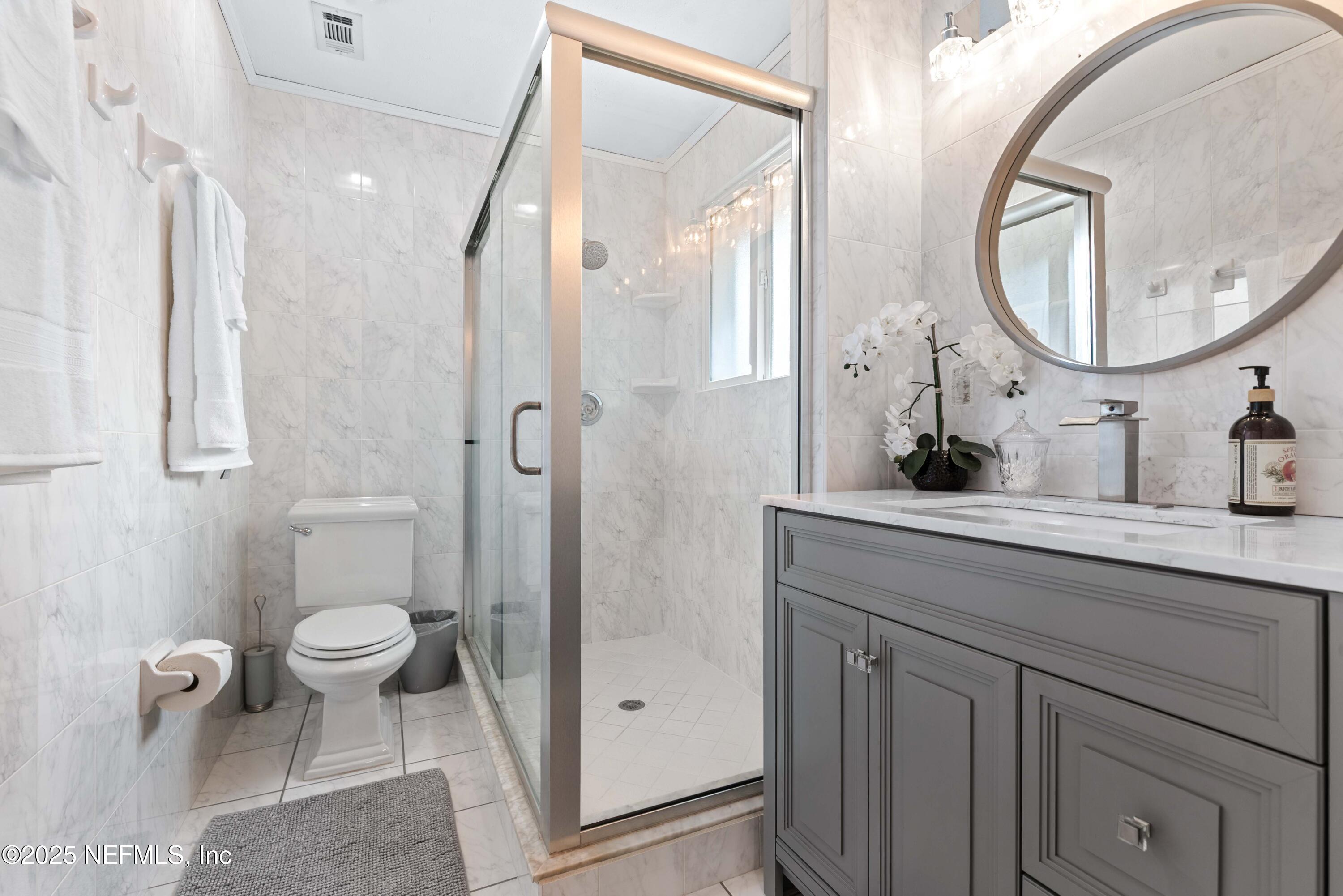 2894 Circle Ridge Drive Orange Park, FL 32065 - Photo 17 of 30 a bathroom with a sink a toilet and a mirror