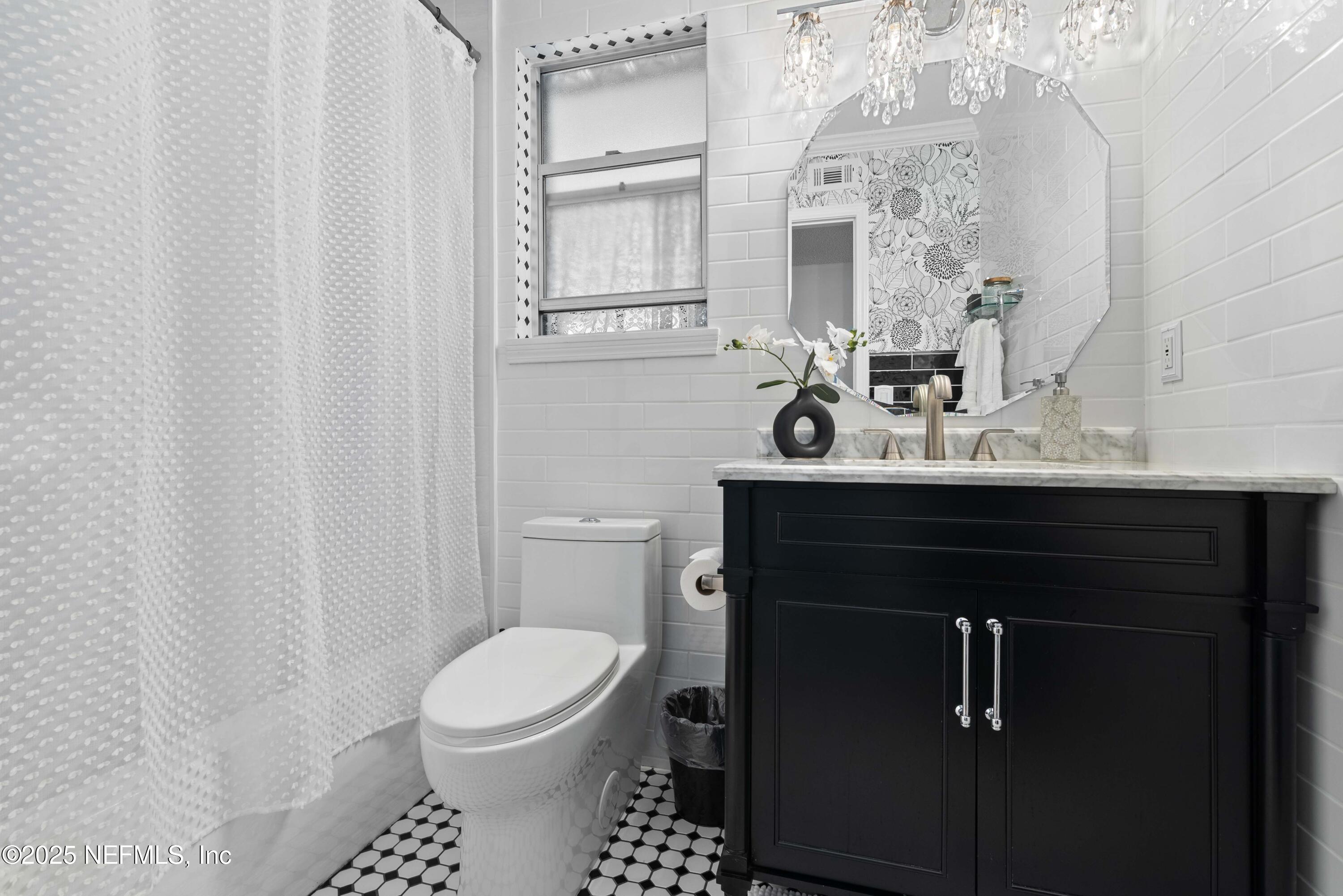 2894 Circle Ridge Drive Orange Park, FL 32065 - Photo 20 of 30 a bathroom with a sink a toilet and a mirror