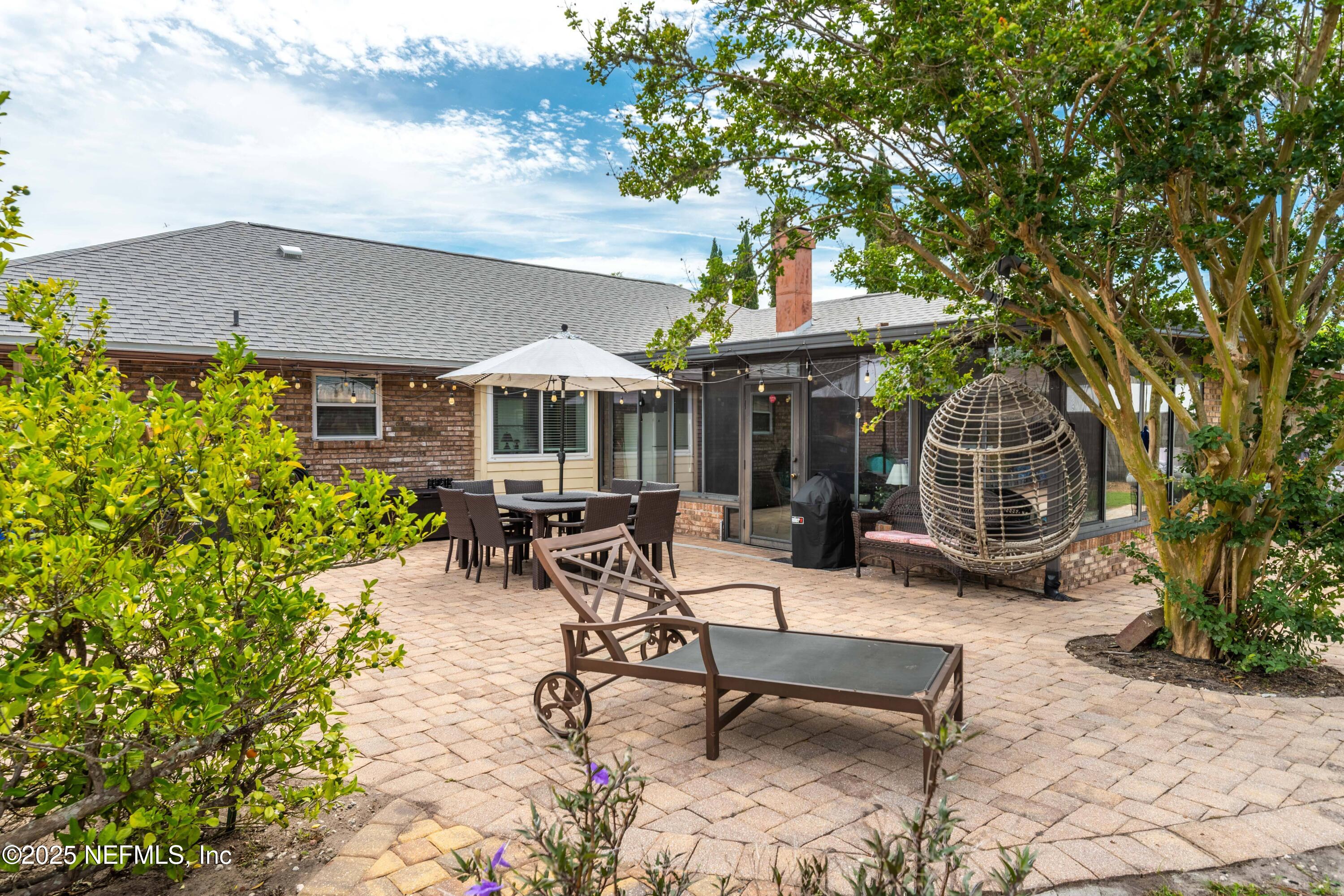 2894 Circle Ridge Drive Orange Park, FL 32065 - Photo 29 of 30 a view of a patio with a table and chairs under an umbrella