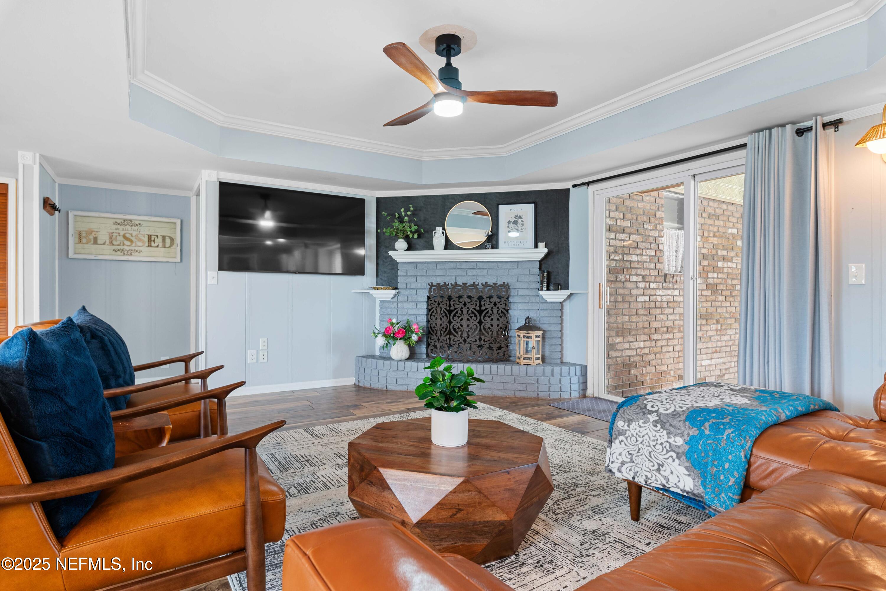 2894 Circle Ridge Drive Orange Park, FL 32065 - Photo 6 of 30 a living room with furniture a fireplace and a flat screen tv