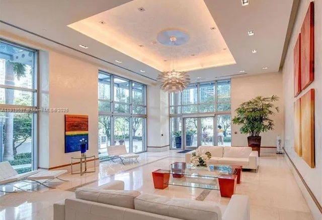 a living room with fireplace furniture and a large window