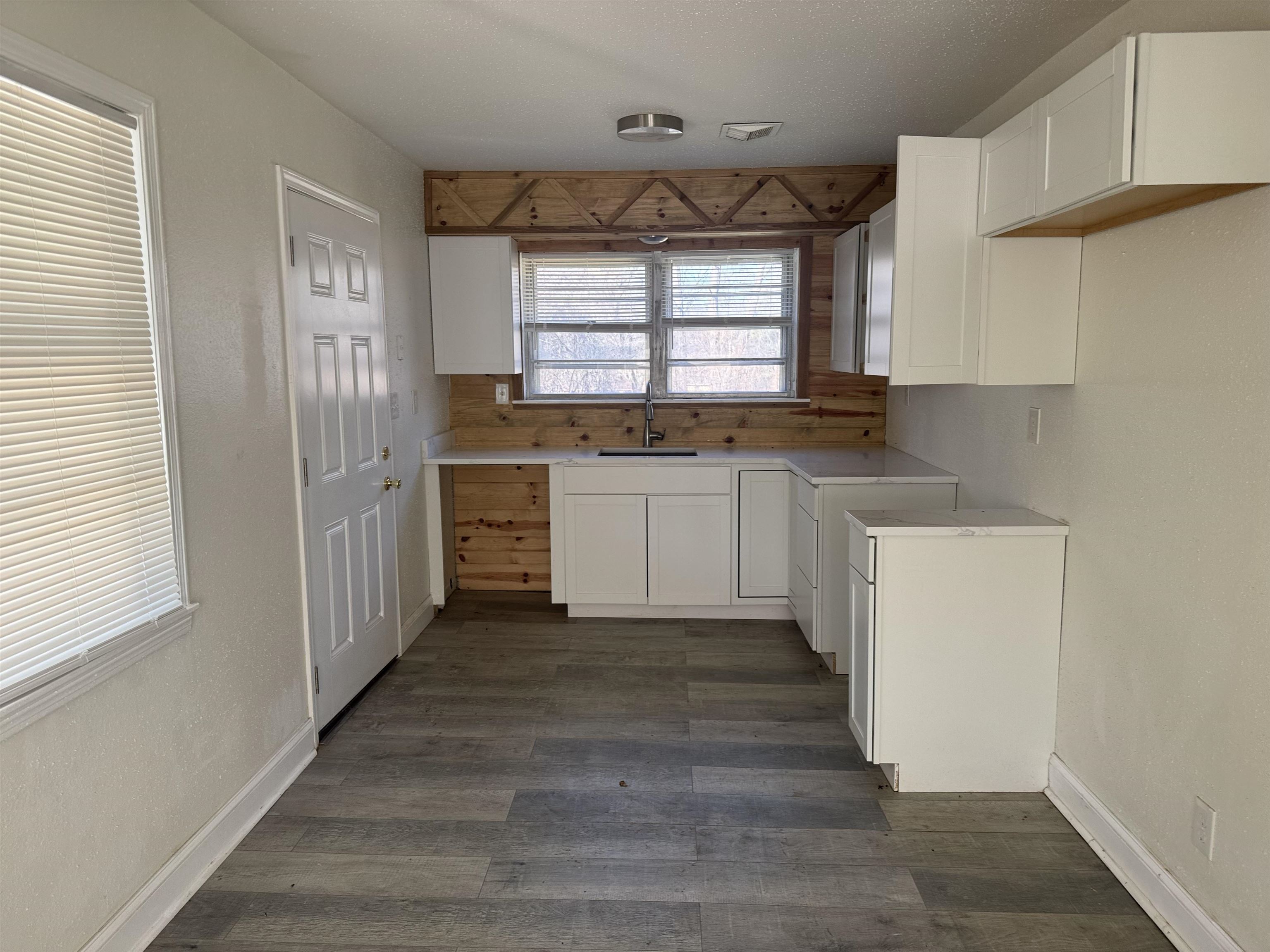 36 West Emory Road Memphis, TN 38109 - Photo 3 of 6 Kitchen featuring white cabinetry and dark wood finished floors