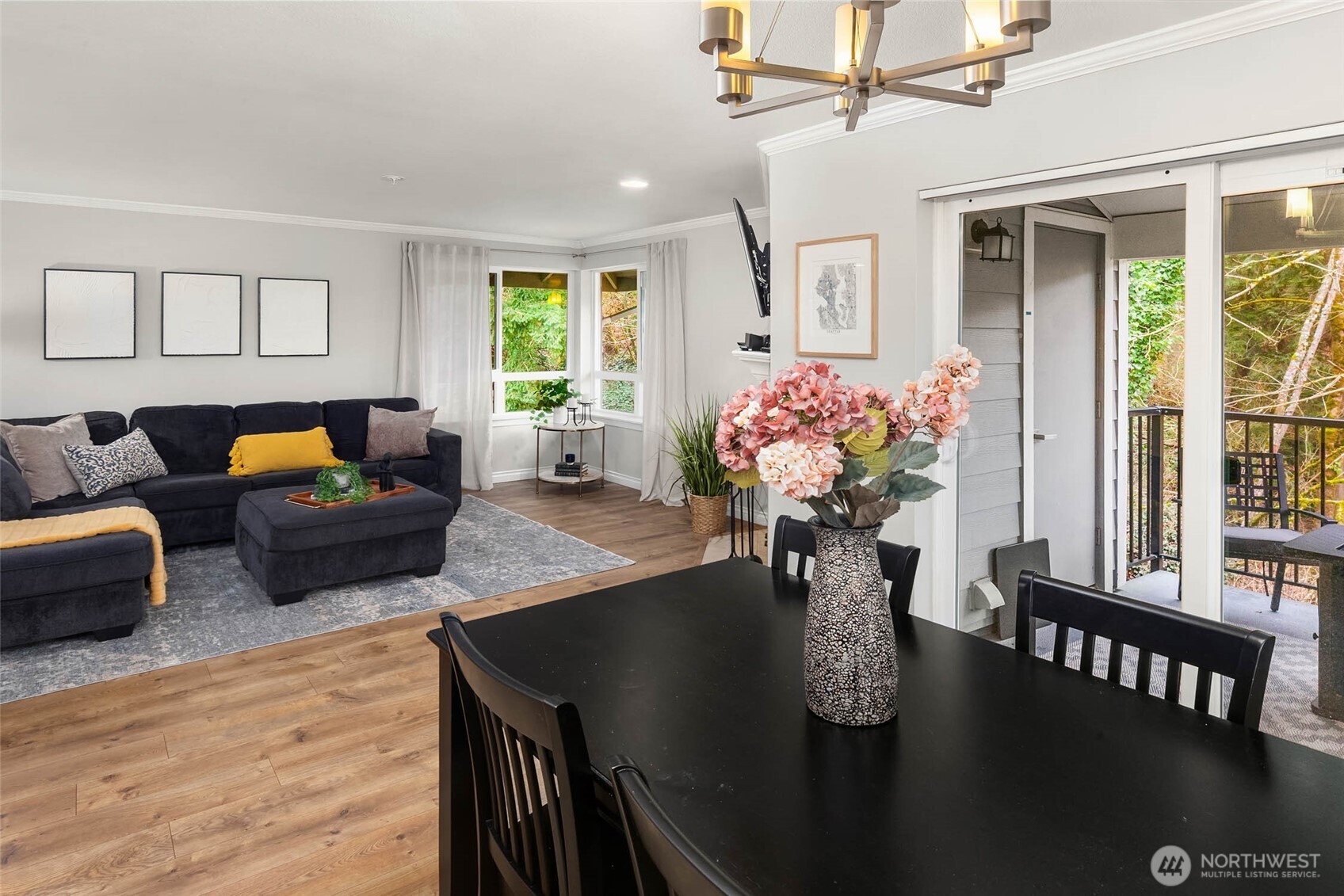 12023 Northeast 204th Place, Unit E302 Bothell, WA 98011 - Photo 13 of 26 a view of a dining room with furniture window and wooden floor