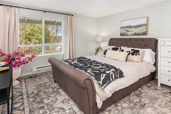 a bed sitting in a bedroom next to a window