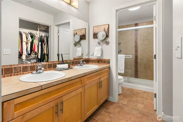 a bathroom with a double vanity sink and mirror