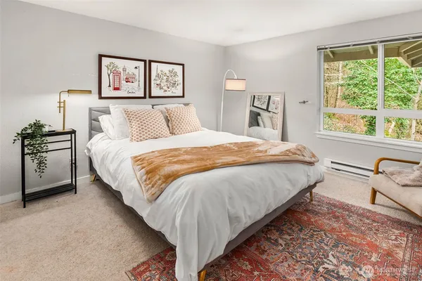 a spacious bedroom with a bed and a large window