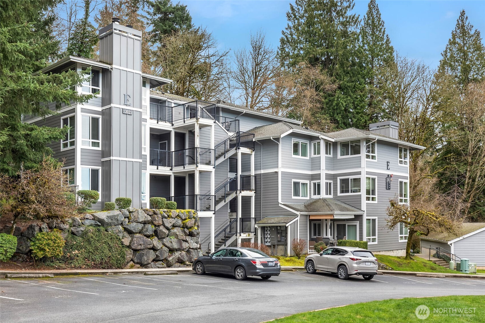 12023 Northeast 204th Place, Unit E302 Bothell, WA 98011 - Photo 22 of 26 a city street lined with buildings and cars
