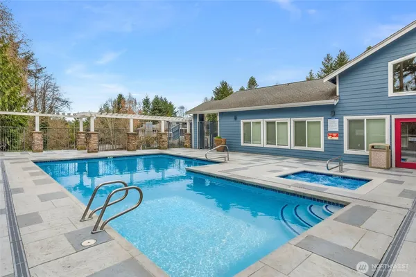 a view of a house with swimming pool and sitting area