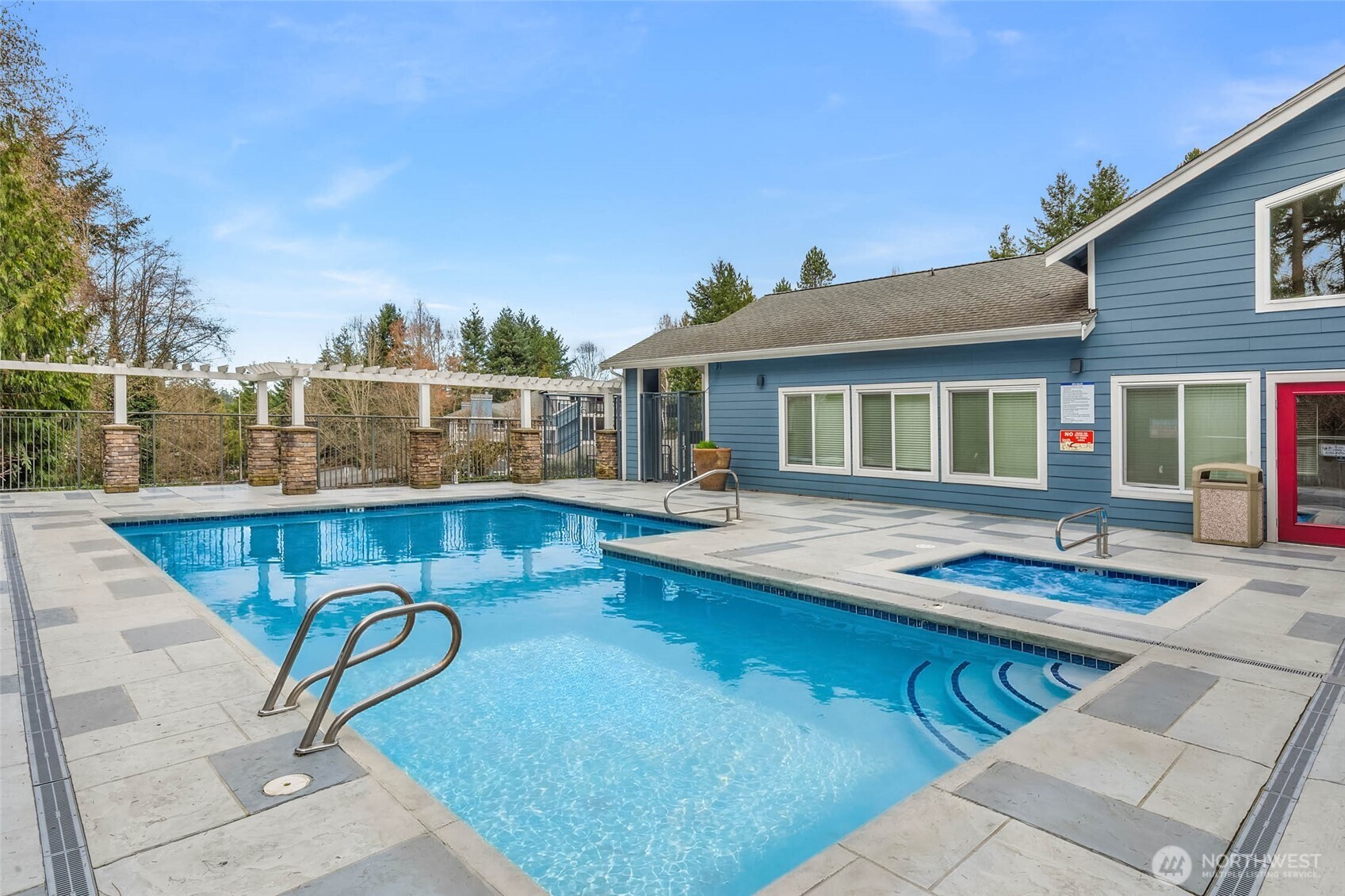 12023 Northeast 204th Place, Unit E302 Bothell, WA 98011 - Photo 24 of 26 a view of a house with swimming pool and sitting area