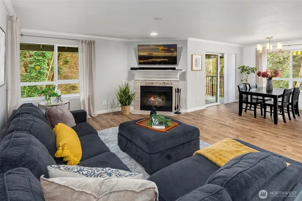 a living room with furniture fireplace and window