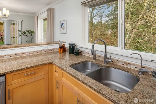 a kitchen with granite countertop a sink and a window