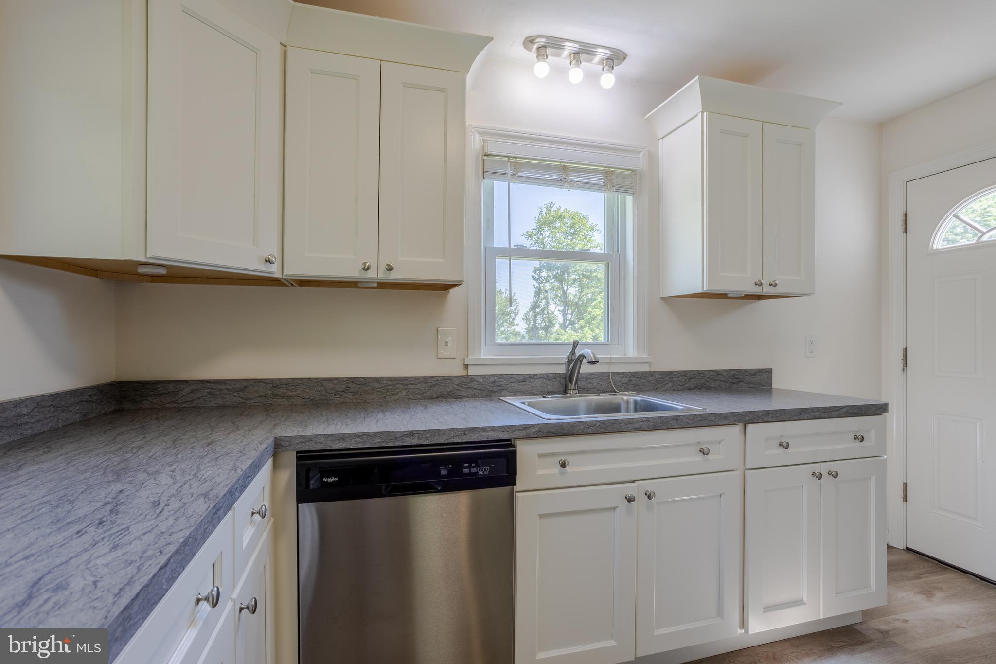 3612 Churchville Road Aberdeen, MD 21001 - Photo 9 of 49 a kitchen with granite countertop white cabinets and window