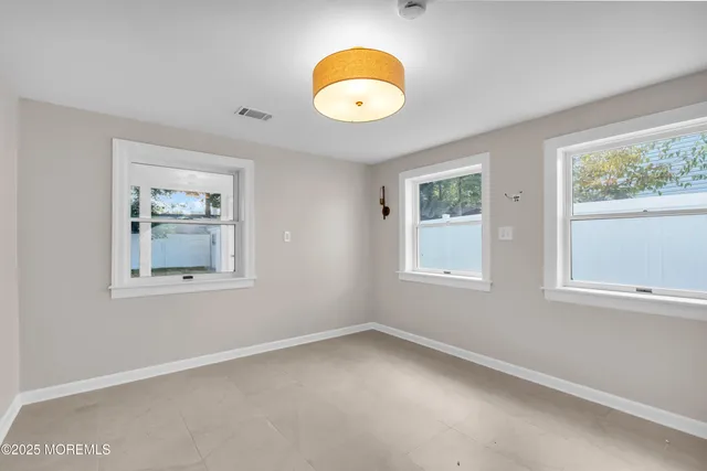 an empty room with windows and windows