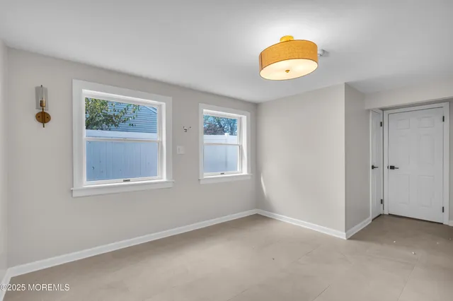 an empty room with window and wooden floor
