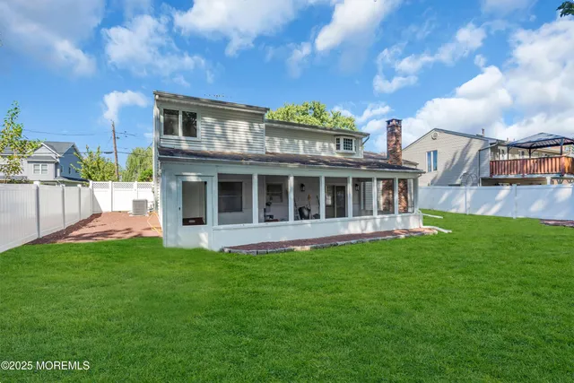 a view of a house with a backyard