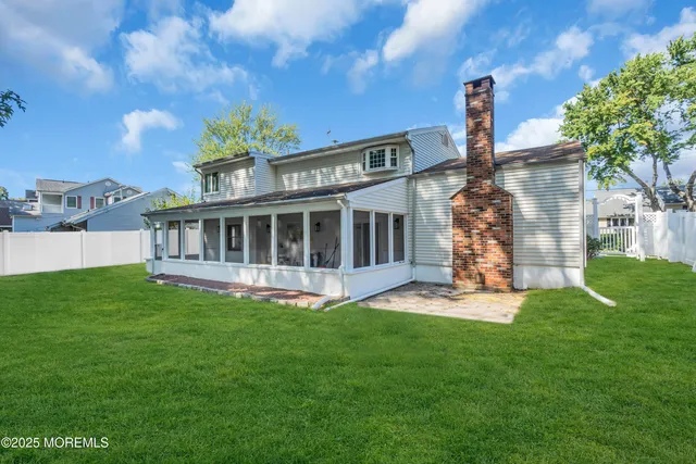 a view of house with backyard and garden