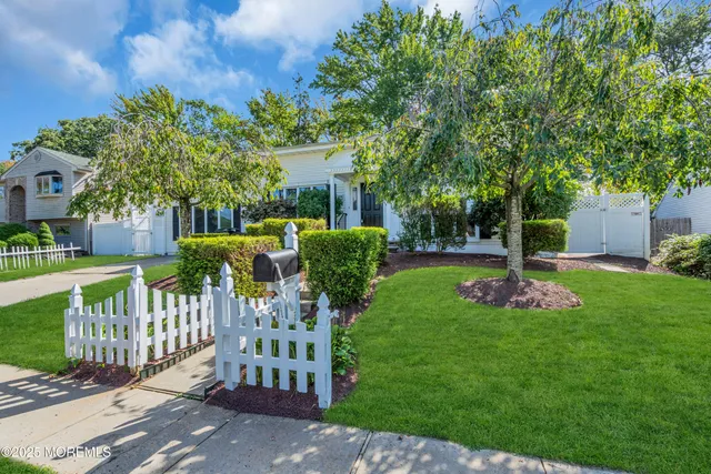a view of a park with a bench plants and trees