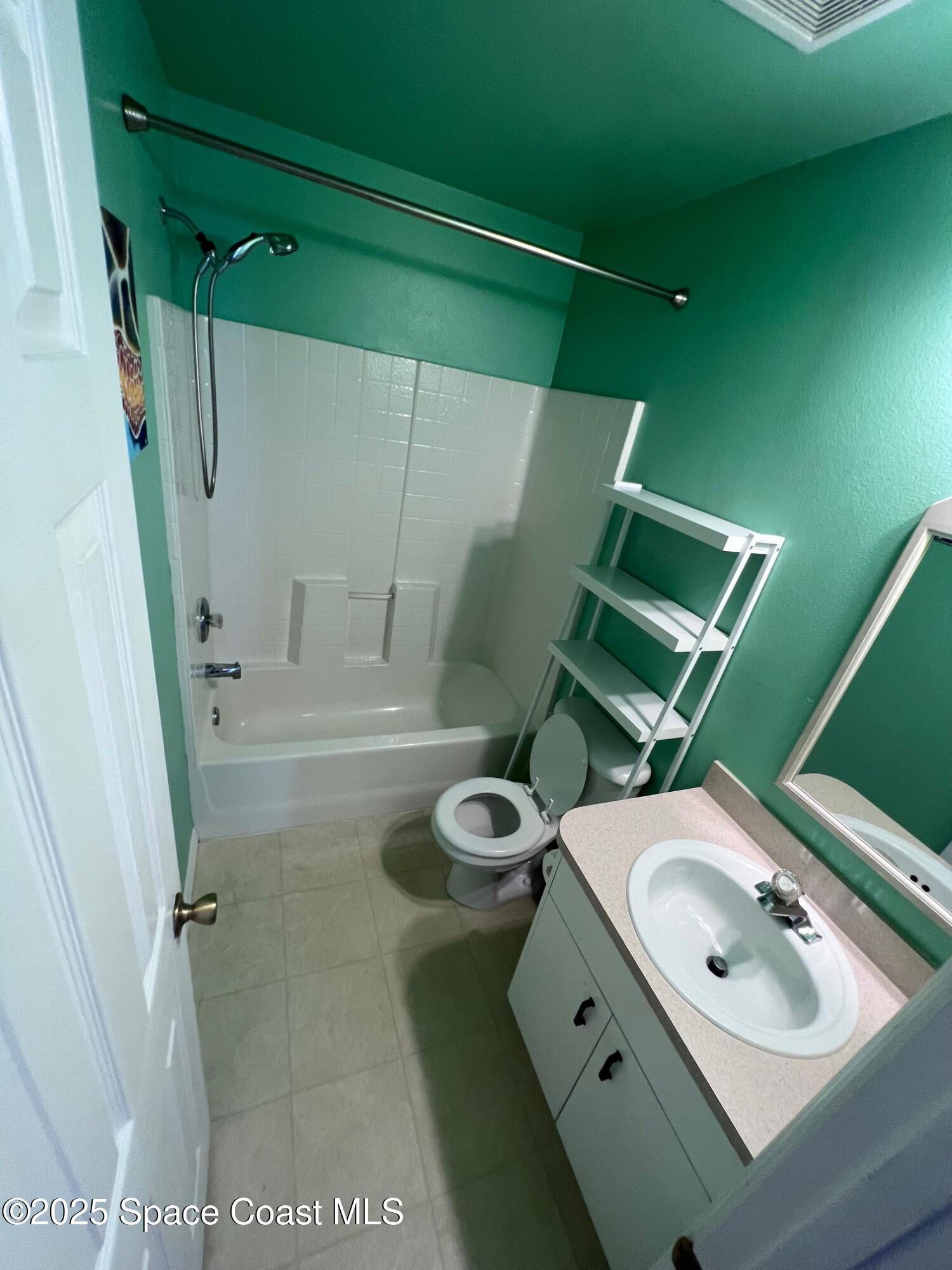2149 Caledonia Place Melbourne, FL 32940 - Photo 14 of 18 a bathroom with a sink mirror toilet and shower