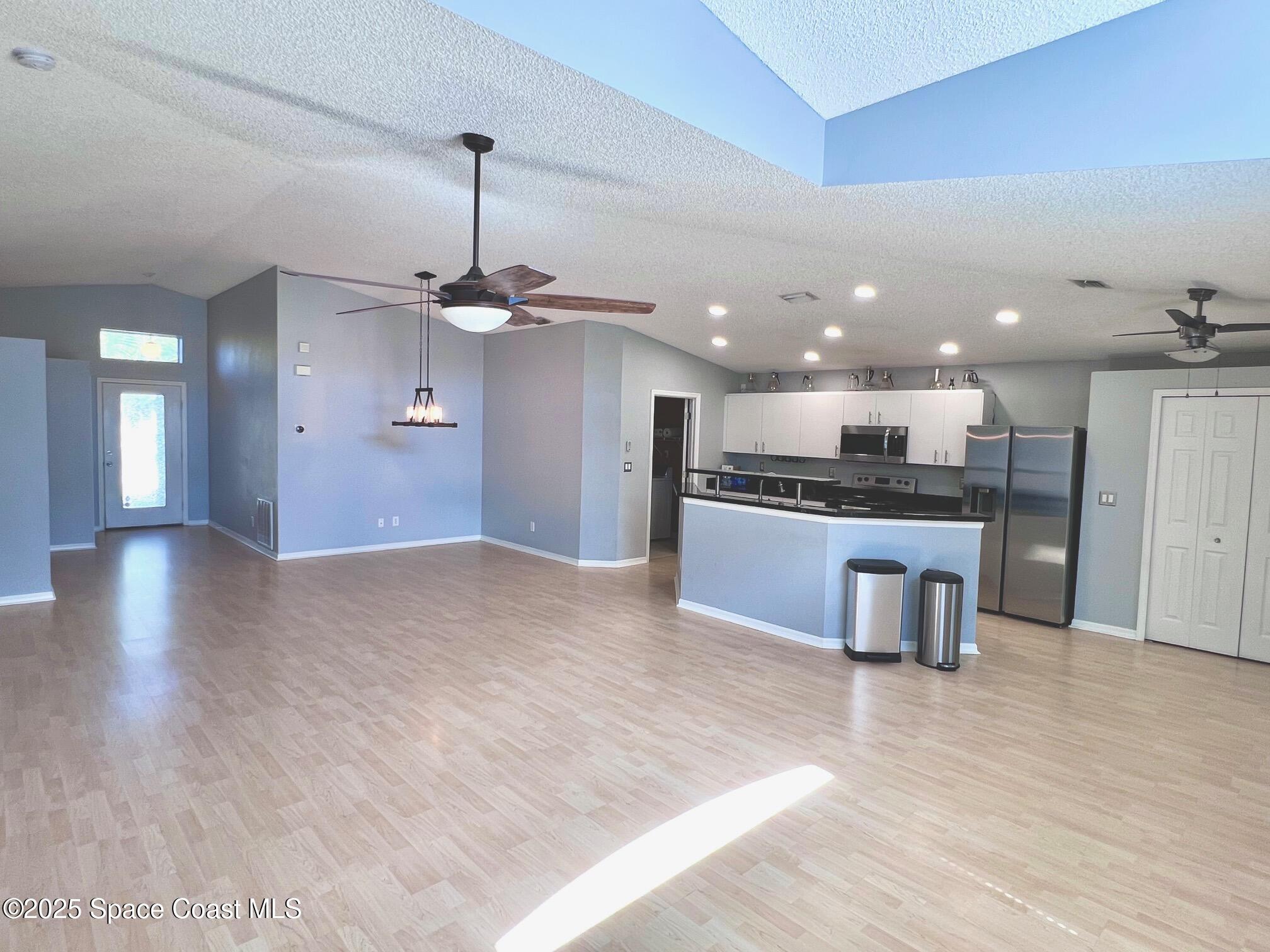 2149 Caledonia Place Melbourne, FL 32940 - Photo 4 of 18 a view of kitchen with refrigerator and window